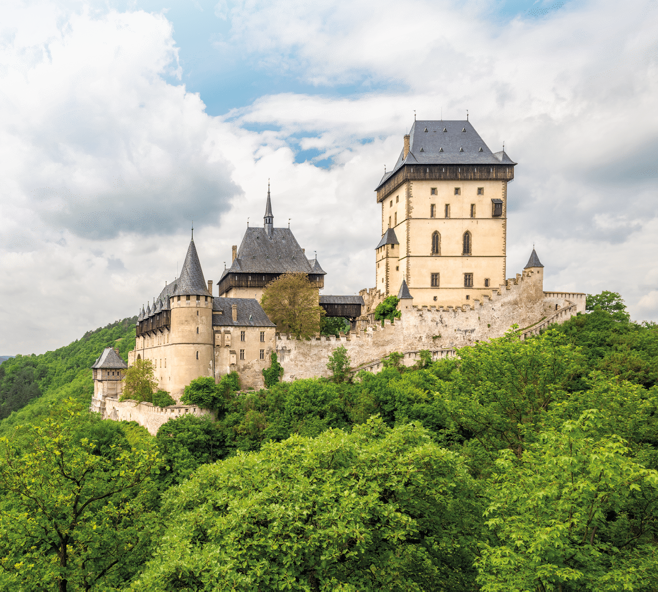 Karlstein, Czech Republic - May 26, 2016: Karlstein Castle is a large Gothic castle founded in 1348 by King Charles IV, Holy Roman Emperor and King of Bohemia. The castle served as a place for safekeeping the Imperial Regalia, Bohemian/Czech crown jewels, holy relics, and other royal treasures. 