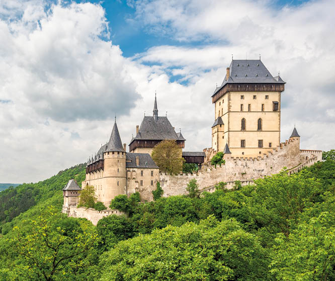 Karlstein, Czech Republic - May 26, 2016: Karlstein Castle is a large Gothic castle founded in 1348 by King Charles IV, Holy Roman Emperor and King of Bohemia. The castle served as a place for safekeeping the Imperial Regalia, Bohemian/Czech crown jewels, holy relics, and other royal treasures. 